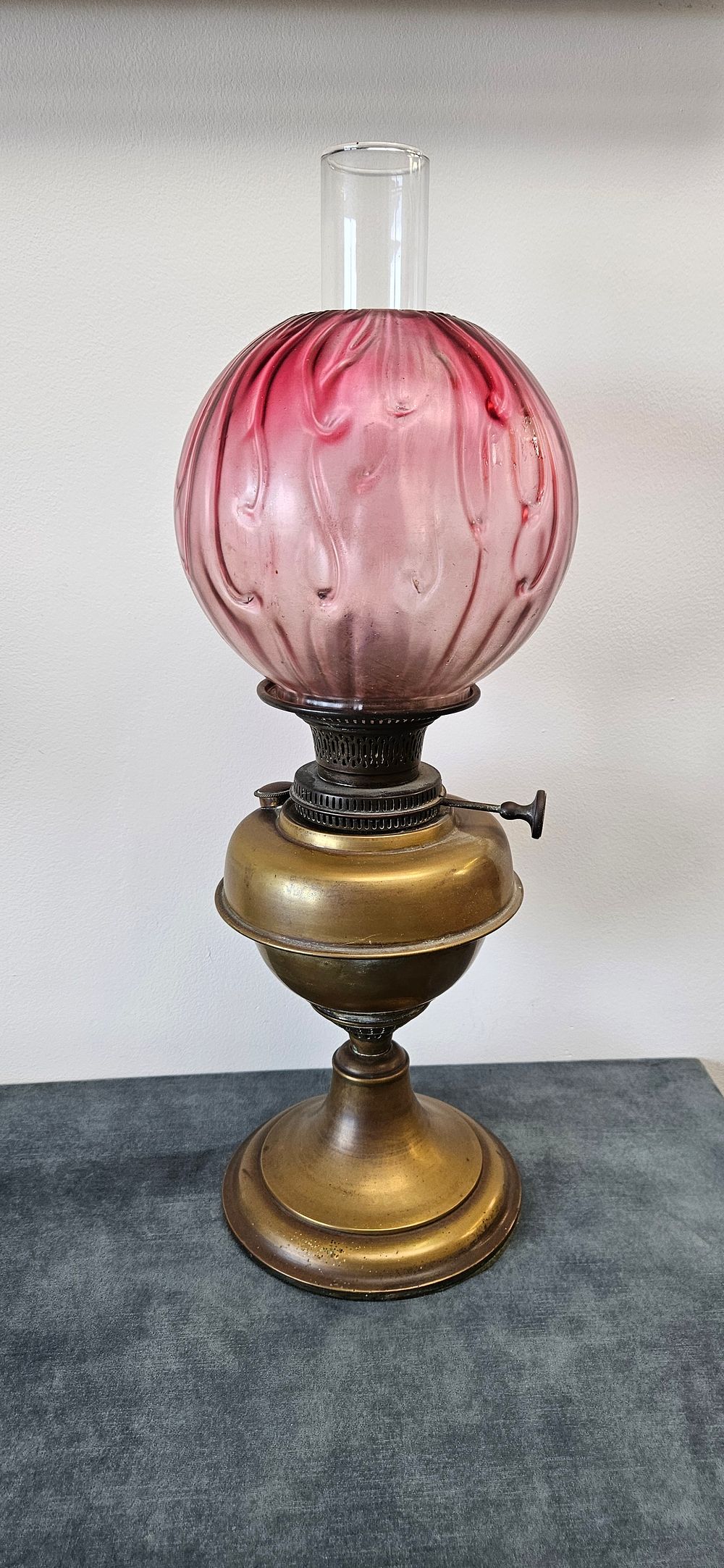 Lot 218: Antique Victorian brass oil lamp with a cranberry...