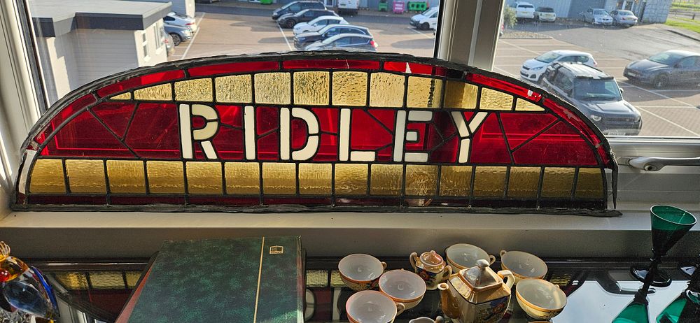 Lot 219: Antique stained glass window panel featuring the name...