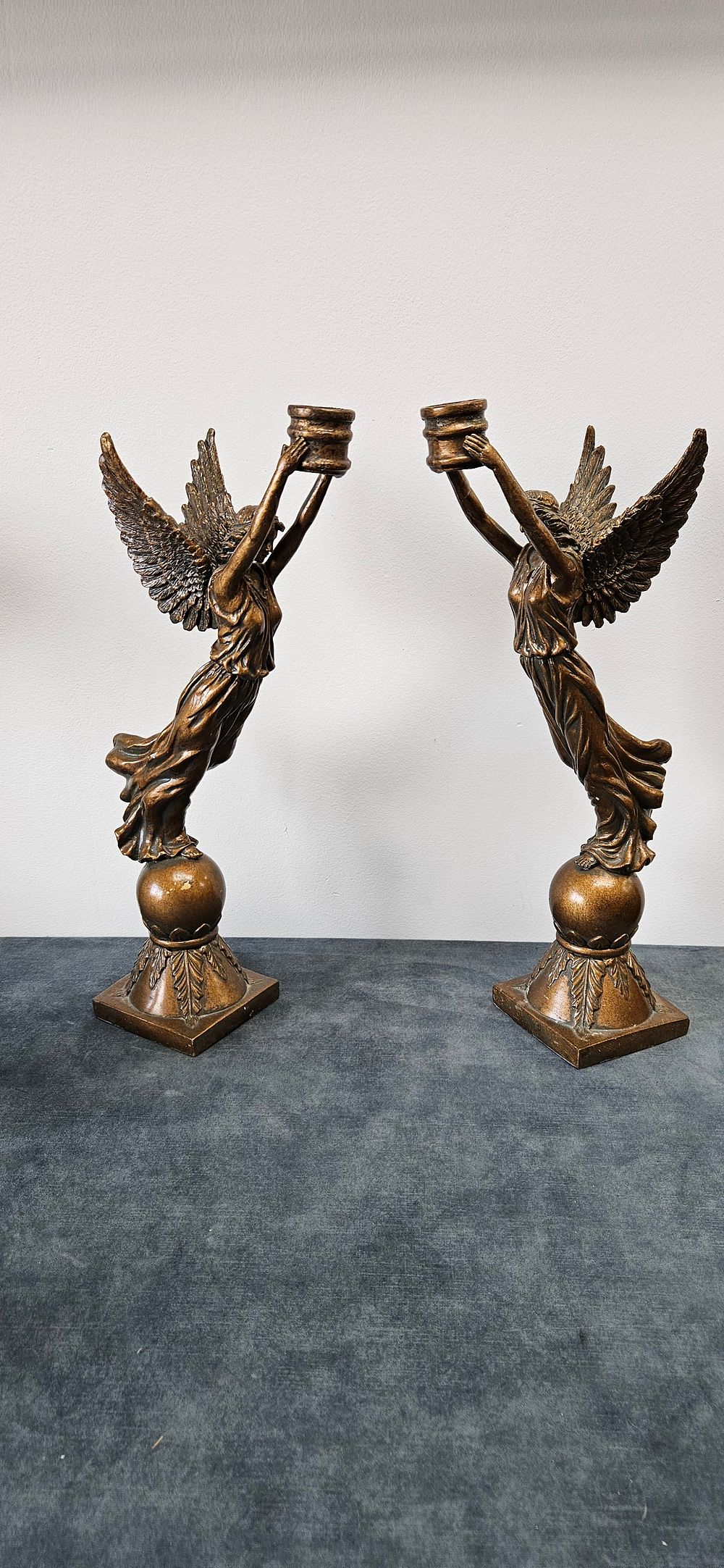 Lot 422: Pair of resin winged angel candle stick holders.