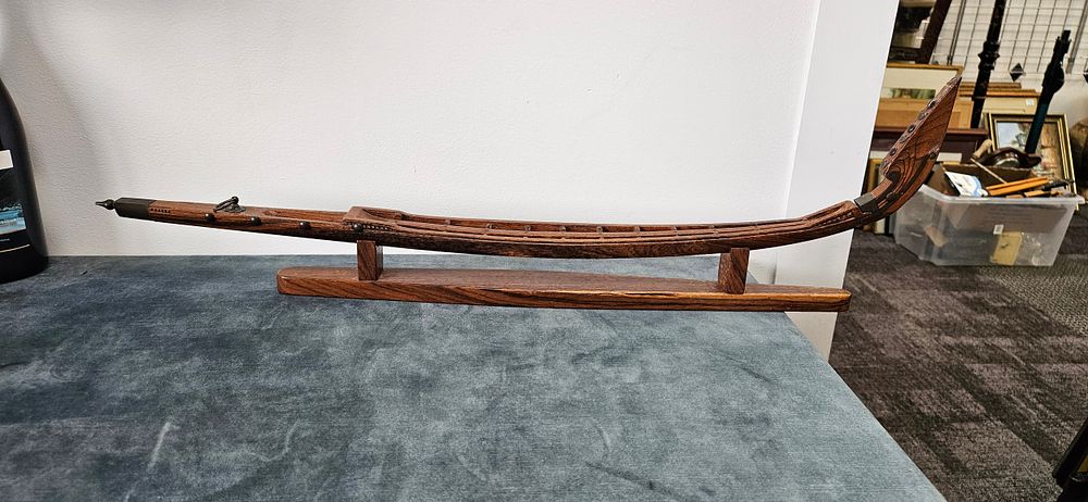 Lot 438: Hand-carved model of a traditional Māori war canoe/...