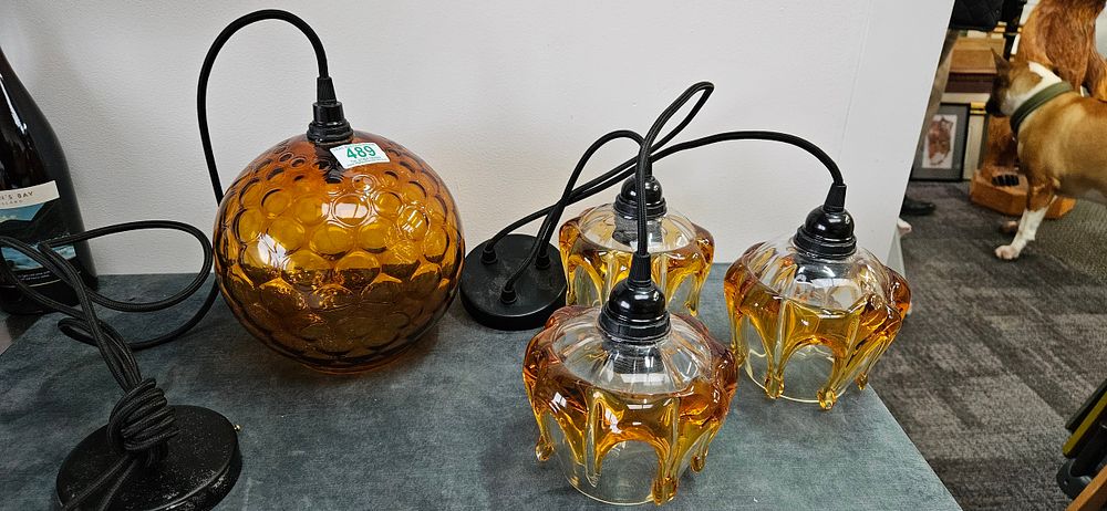 Lot 489: 2 x Amber glass pendant lights.