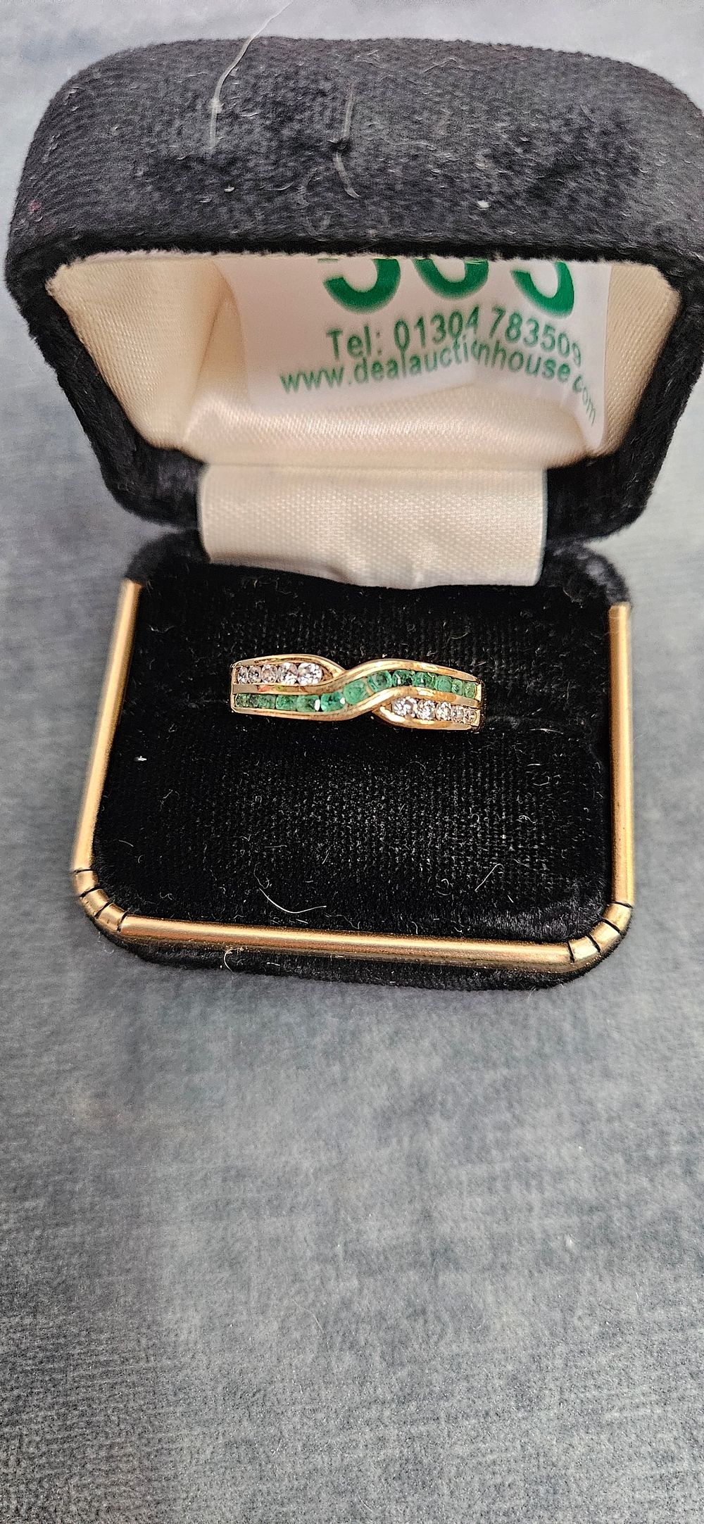Lot 503: 9ct Yellow gold emerald and clear stone crossover...