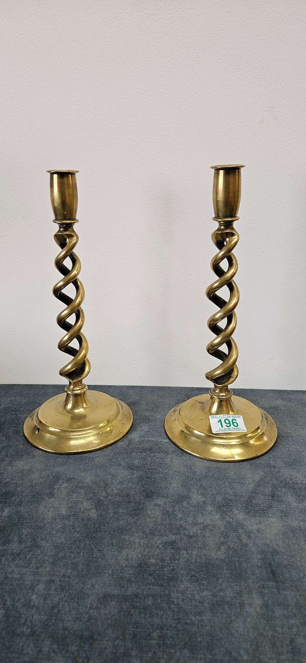 Lot 160: Pair of brass barley twist candlesticks.