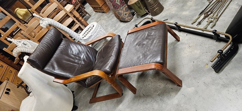 Lot 197: IKEA Poäng armchair and matching footstool in dark...