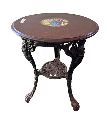 Tavolino di forma tonda in ghisa con piano in legno decorato, periodo XIX/XX secolo. 