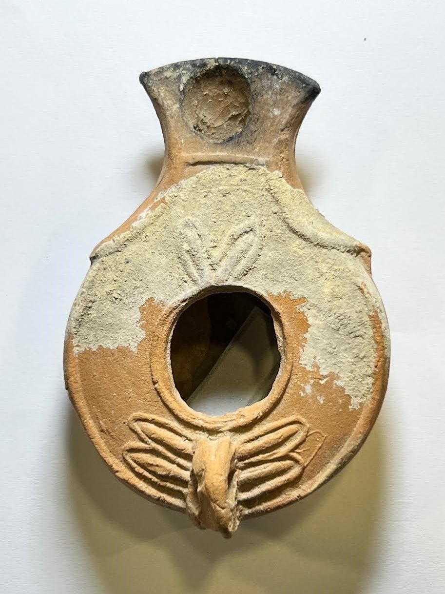 A Southern Type Terracotta Oil Lamp. 1st - 2nd century CE. 8.4 cm. Decorated with leaves. 