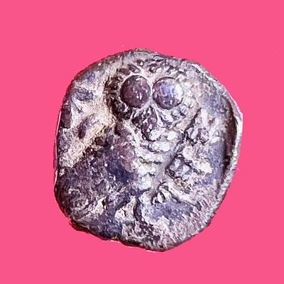 Yehud, 4th century BCE. Silver obol, 0.5 gr; 7 mm in diam. Obv: Plain. Rev: Owl standing to r. 