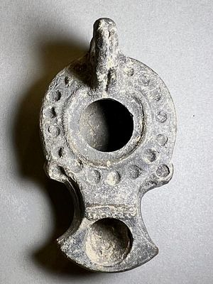 A Rare Small Southern-Type Gray Terracotta Oil Lamp. 1st - 2nd century CE. 6.7 cm. Decorated 