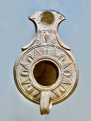 A Jewish Southern-Type Terracotta Oil Lamp. 1st - 2nd century CE. 10.6 cm. Decorated with an 