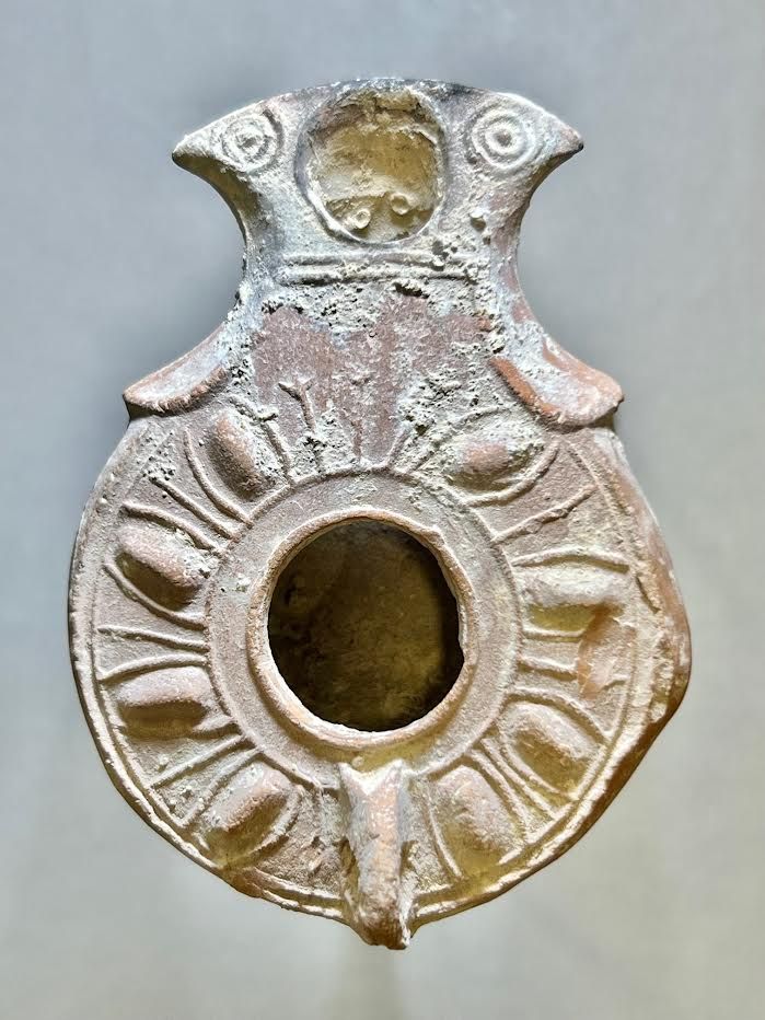 A Jewish Southern-Type Terracotta Oil Lamp. 1st - 2nd century CE. 8.7 cm. Decorated with leaves 