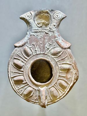 A Jewish Southern-Type Terracotta Oil Lamp. 1st - 2nd century CE. 8.7 cm. Decorated with leaves 