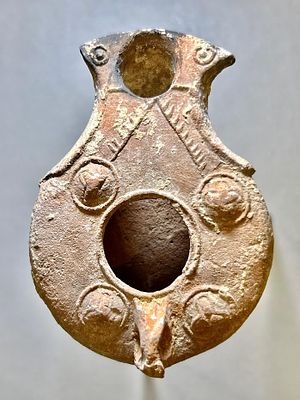 A Jewish Southern-Type Terracotta Oil Lamp. 1st - 2nd century CE. 8.2 cm. Decorated with 4 