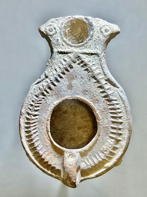 A Jewish Southern-Type Terracotta Oil Lamp. 1st - 2nd century CE. 8.5 cm. Decorated with a 
