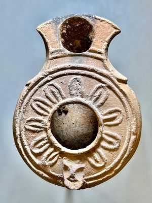 A Jewish Southern-Type Terracotta Oil Lamp. 1st - 2nd century CE. 7.6 cm. Decorated with 