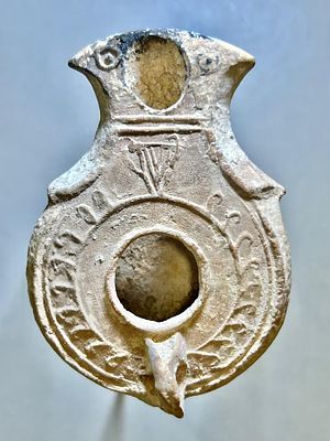 A Jewish Southern-Type Terracotta Oil Lamp. 1st - 2nd century CE. 8.3 cm. Decorated with a 