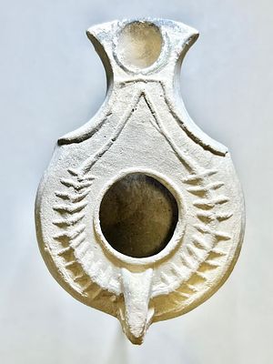 A Jewish Southern-Type Terracotta Oil Lamp. 1st - 2nd century CE. 8.5 cm. Decorated with a 