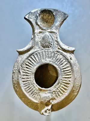 A Jewish Southern-Type Terracotta Oil Lamp. 1st - 2nd century CE. 8.3 cm. Decorated with a sea 