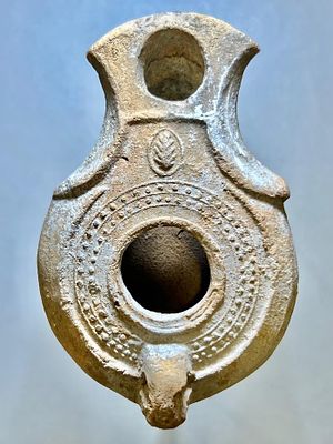A Jewish Southern-Type Terracotta Oil Lamp. 1st - 2nd century CE. 9.5 cm. Decorated with a leaf 