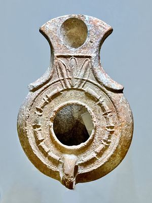 A Jewish Southern-Type Terracotta Oil Lamp. 1st - 2nd century CE. 9.3 cm. Decorated with 3 