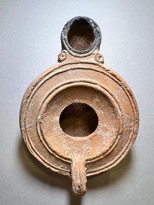 A Jewish Southern-Type Round Terracotta Oil Lamp. 1st - 2nd century CE. 9.2 cm. Decorated with 
