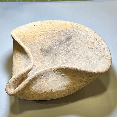 A Canaanite Terracotta Oil Lamp. Late Bronze Age, 1550 - 1200 BCE. 16.7 cm in diam. In very 