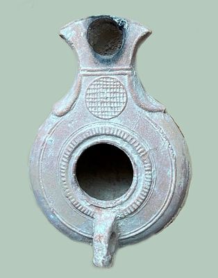 A Jewish Southern-Type Terracotta Oil Lamp. 1st - 2nd century CE. 8.9 cm. Decorated with a 