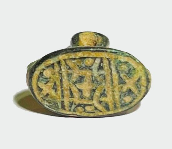 A Cast Bronze Pendant-Seal. . Iron Age II, 8th - 7th century BCE. 19.4 mm high. Depicting 