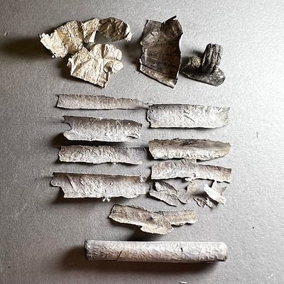 A Jewish Aramaic Silver Scroll Amulet. 4th - 5th century CE. 4 cm. Partly opened. In good 