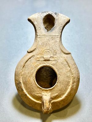 A Jewish Southern Type Terracotta Oil Lamp. 1st - 2nd century CE. 9.7 cm. Decorated with a bird 
