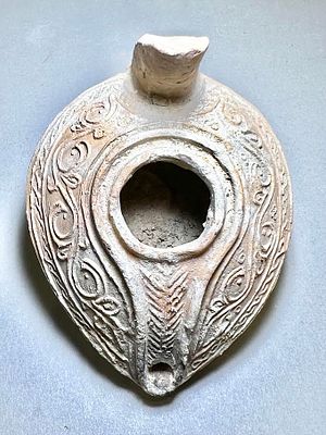 An Islamic Terracotta Oil Lamp. 8th - 10th century CE. 8.8 cm. Decorated with geometric floral 