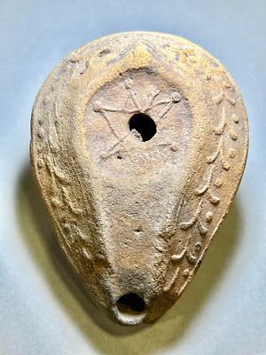 An Islamic Terracotta Oil Lamp. 7th - 8th century CE. 9.7 cm. With floral and geometric motifs. 