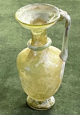 A Yellowish Glass Juglet. Byzantine Period, 4th - 5th century CE. 13.4 cm high. Decorated with 
