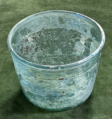 A Late Roman Green Glass Bowl. Byzantine Period, ca 4th - 5th century CE. 11.9 cm in diam, 8.5 