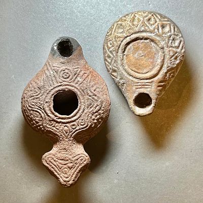 A Lot of 2 Terracotta Oil Lamps. 3rd - 4th century CE. 10.2 and 7.2 cm. Decorated with 