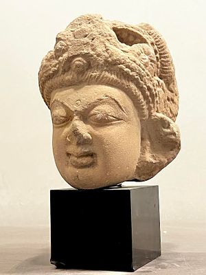 An Indian Light-Brown Sandstone Female Head. Central India, Khujuraho, 6th - 7th century CE. 