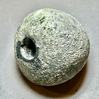A Chalcolithic Copper Mace-head. 4th Millennium BCE. 4.8 cm high; 367 gr. Longwise perforate. 