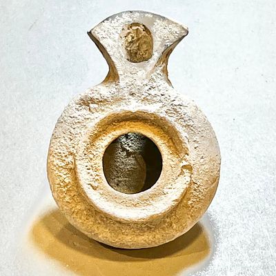A Herodian Terracotta Oil Lamp, 1st century CE. 7.7 cm. Covered with some calcite encrustation. 