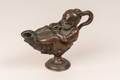 Padovan Oil Lamp, bronze cast with central foot. Handgrip. Lying man with leafes. Two oil 