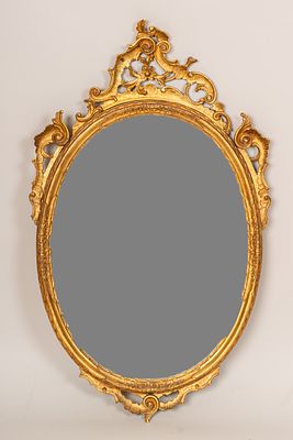 Venetian Mirror, oval shape. With rich wooden carved rococo open work decorations. Later mirror 
