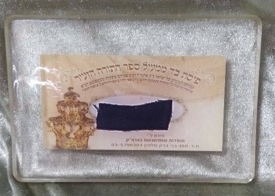 פיסת בד ממעיל ספר תורה הזעיר המיוחס למושיען של ישראל האדמו"ר רבי אברהם מתיתיהו משטפנשט, שהועלה 