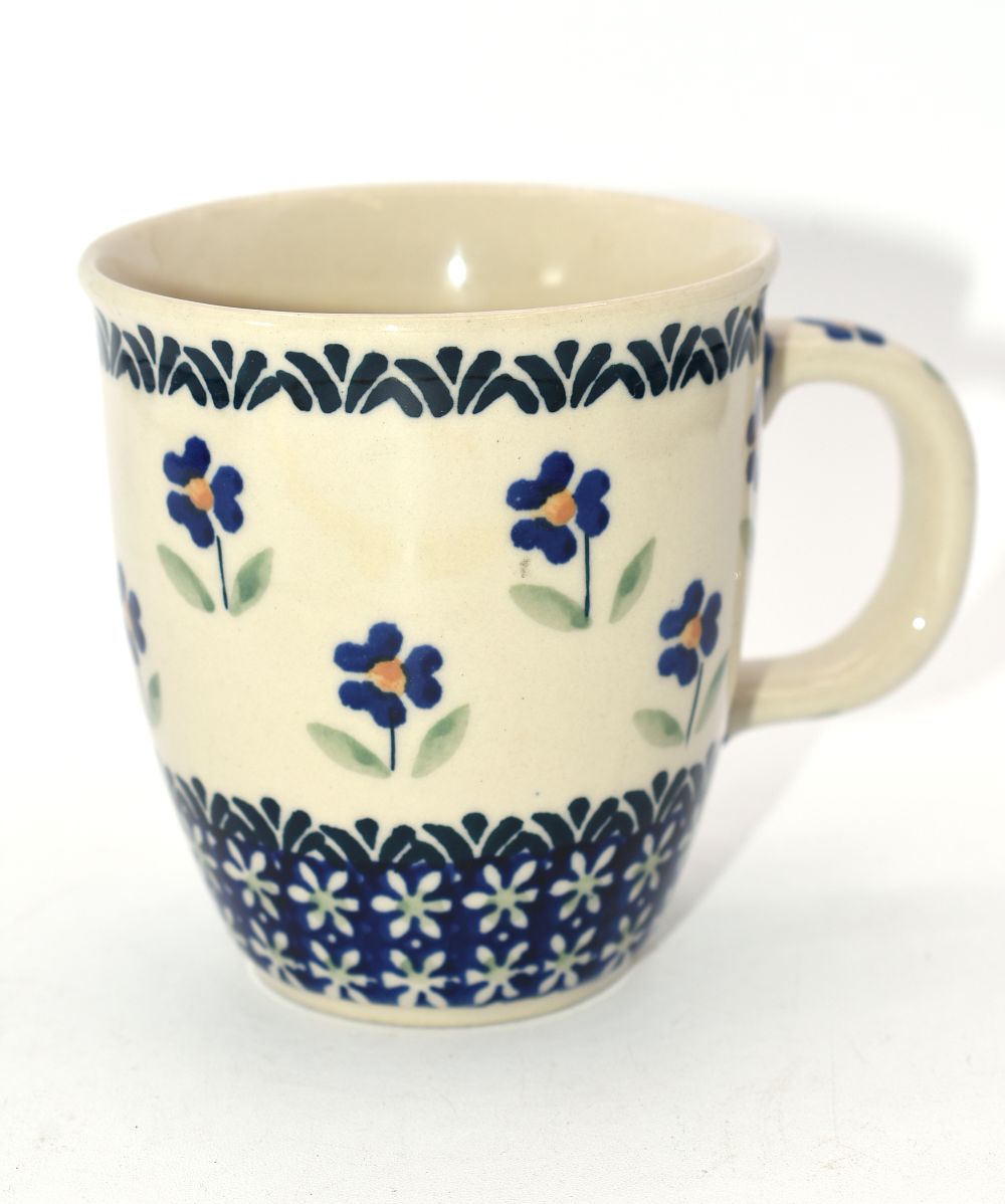 Hand Made Polish Pottery Blue Daisy Floral Mug. A cream-colored ceramic mug, approximately 4.25" 