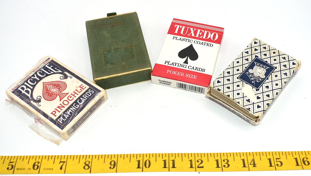 A Group of Playing Cards and Pinochle Card Case. A dark green playing card case embossed 