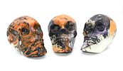 Three Decorative Hydro-Dipped Plastic Skulls. Three decorative skulls, predominantly black Image - 1