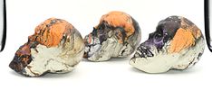 Three Decorative Hydro-Dipped Plastic Skulls. Three decorative skulls, predominantly black Image - 2