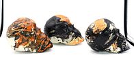 Three Decorative Hydro-Dipped Plastic Skulls. Three decorative skulls, predominantly black Image - 4