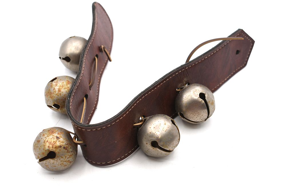Five Silver-Colored Metal Sleigh Bells on Leather Strap. Five silver-colored metal sleigh bells 