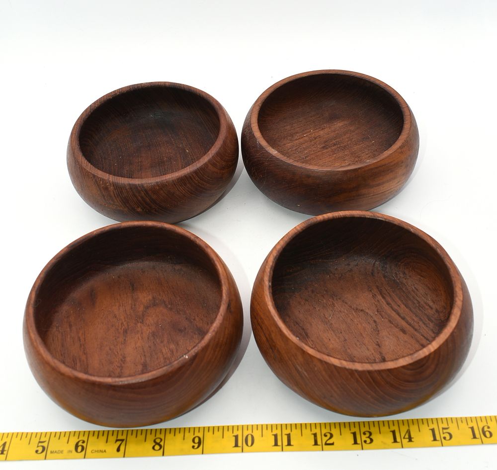 Set of Four Vintage Teak Wood Salad Bowls. A set of four dark brown wooden bowls, likely teak 