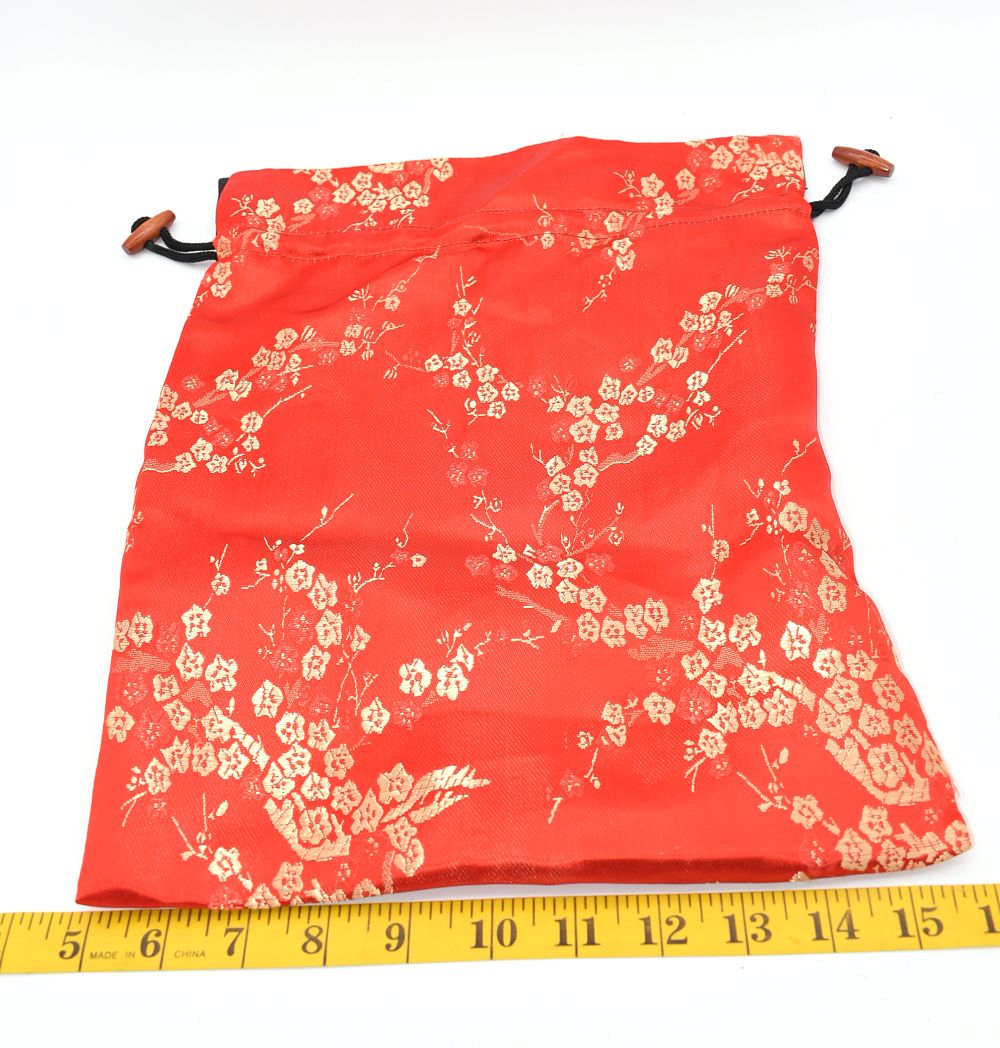 Red Drawstring Bag with Gold Floral Patterns and Wood Beads. A red drawstring bag with gold 