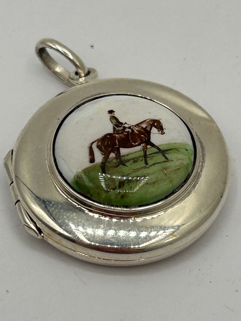 Lot 362: Lovely Little Silver Locket With Horse Theme.