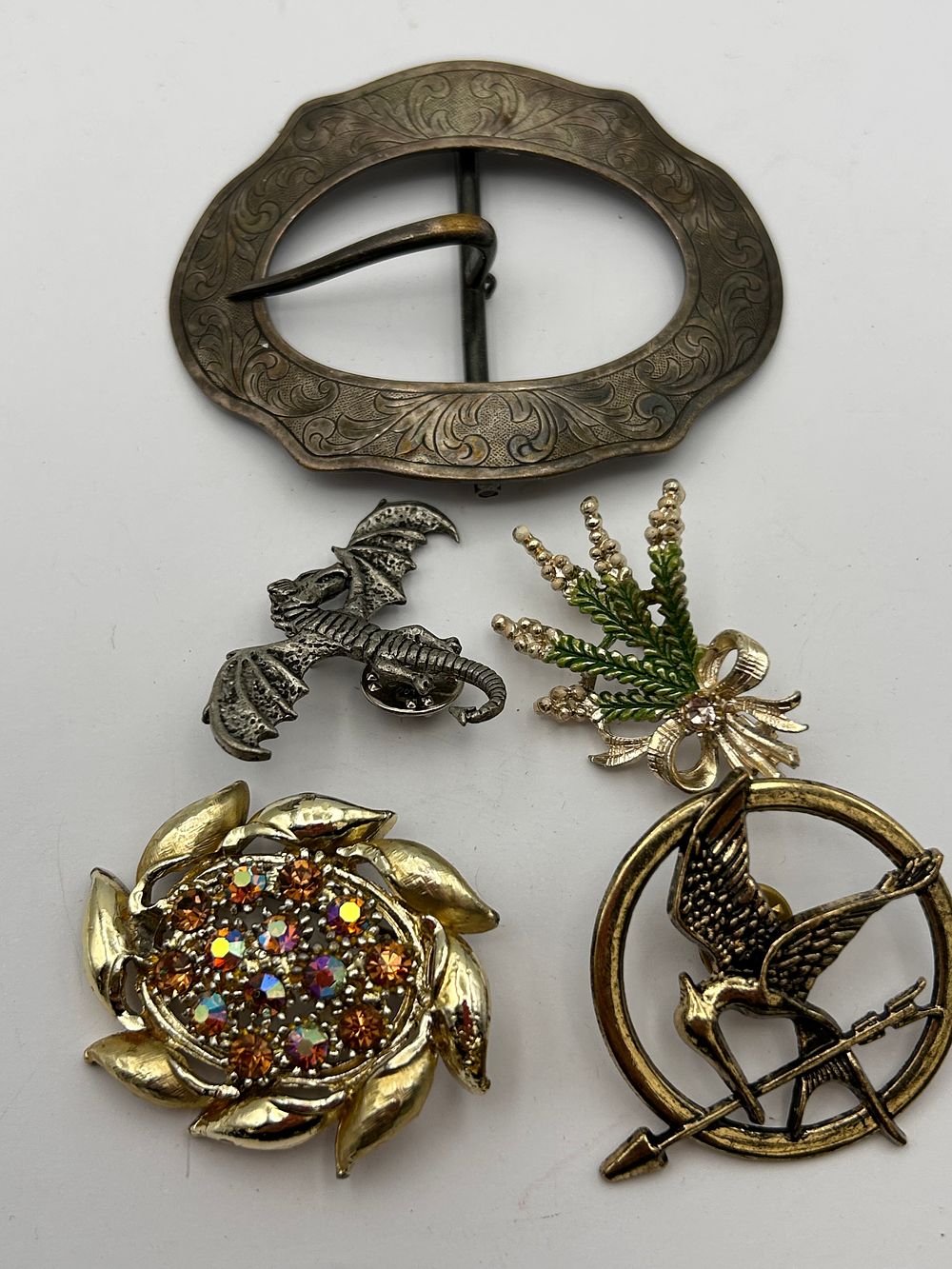 Lot 369: A Collection of Five Assorted Costume Jewelry Items and a Belt Buckle